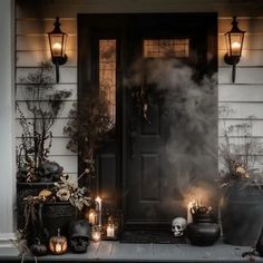 a front porch decorated for halloween with candles and skulls