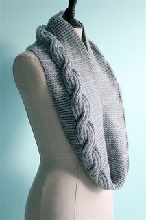 a gray knitted scarf on top of a mannequin