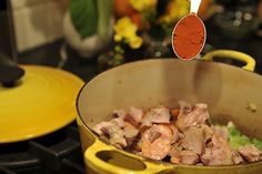 a pot filled with meat sitting on top of a stove