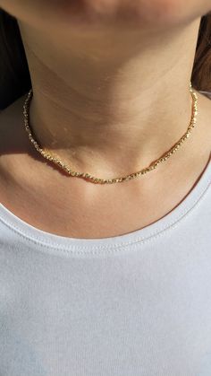 PRODUCT DETAILS: Elevate your style with our Golden Elegance Choker Necklace. This stunning piece features 3mm Gold Dorica beads, creating a timeless and stylish look. The choker is delicately gold-plated, adding an extra layer of elegance. It's a versatile accessory that seamlessly transitions from everyday wear to special occasions. Our choker is a fashion statement, combining classic gold style with a modern touch. Embrace the charm of minimalist luxury with this unique and dainty gold-plated necklace. CARE:  Keep jewelry dry and avoid contact with water, lotions, etc SIZE: If you want a different length, write the size in the message to seller box when you check out. Lenght: 15-16 inch/38-41 cm. PACKAGING: Each order comes with a lovely gift box Please check your bracelets size when yo Dainty Gold Beaded Necklace With Faceted Beads, Dainty Gold Beads With Beaded Chain, Dainty Gold Beaded Necklaces, Dainty Gold Beaded Chain, Gold Dainty Beaded Necklace With Faceted Beads, Dainty Beaded Necklaces With Gold Beads, Adjustable Chain Necklace With Round Tiny Beads, Gold Choker With Round Beaded Chain, Dainty Gold Beads For Jewelry Making