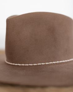 This hat band mixes beautiful faceted glass beads with brass accents to create a subtle sparkle to add to your hat. Material: Faceted glass beads & brass beads Dimensions: 21" beaded length Closure: Adjustable slide closure Color Options: Black, Gray, Beige, Blue Handmade by Crossbow in the mountains of Telluride, CO. Hat Chain, Beaded Hat Bands, Beaded Hat, Brass Beads, Belt Purse, Crossbow, Brass Accents, Accessories Bags Purses, Hat Band