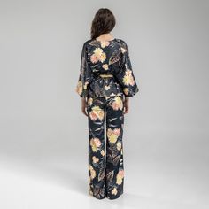 Experience effortless style and comfort with our Balance Kimono Top. This viscose blend kimono features an asymmetrical design and a v-neckline. The beautiful floral print adds a touch of femininity to the pinstriped fabric. This kimono top features an inset adjustable belt at backwaist to quickly alter it to your silhouette. Dress it up with heels or dress it down with trainers for a versatile look. 40% CO 40% VI 15% PE 5% EA  Fine wash at 30 degrees Iron at middle heat Do not tumble dry Bohemian V-neck Sets For Spring, Spring V-neck Beachwear Sets, Elegant Beach Sets For Spring, Spring Printed Viscose Sets, Bohemian V-neck Spring Sets, Elegant V-neck Kimono For Spring, Chic Floral Print Sets For The Beach, V-neck Sets For Spring Brunch, Spring Brunch V-neck Sets