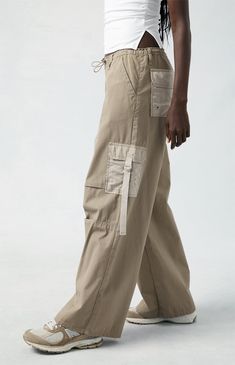 Level up your streetwear style with the PacSun Brown Toggle Baggy Cargo Pants. These on-trend mid-rise pants combine edgy style with comfort, featuring a baggy fit, cargo pockets, and an adjustable toggle waist for a customizable fit. Urban Style Wide Leg Khaki Cargo Jeans, Urban Style Khaki Wide Leg Cargo Jeans, Y2k Streetwear Parachute Pants With Pockets, Y2k Parachute Pants For Streetwear With Pockets, Urban Khaki Wide Leg Cargo Jeans, Urban Wide Leg Khaki Cargo Jeans, Trendy Khaki Cargo Jeans For Streetwear, Urban Style Straight Leg Parachute Pants For Summer, Khaki Wide Leg Pants For Streetwear