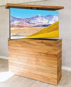 a flat screen tv sitting on top of a wooden stand in front of a wall