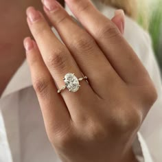 a woman's hand with a diamond ring on it