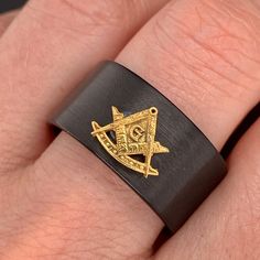 Celebrate his accomplishments with this stunning Tungsten Masonnic Wedding Ring, The ring features a 3D square and compass symbol, that is made of solid 14k yellow gold. Stunning and detailed this12 mm Black Masonic Tungsten Ring is durable and fashionable. The inside shank is rounded for Comfort fit. For a design modification or custom request, please contact me through Etsy messages. For more designs from DINARA STUDIO please visit the shop; https://www.etsy.com/shop/DinaraStudio?ref=seller-pl Custom Black Jewelry For Formal Occasion, Custom Black Formal Jewelry, Symbolic Black Wedding Jewelry, Symbolic Black Jewelry For Wedding, Custom Black Jewelry For Anniversary, Custom Engraved Black Rings, Custom Black Engraved Rings, Compass Symbol, 3d Square