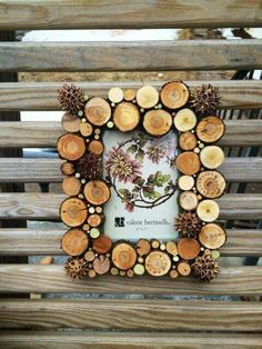 a frame made out of wood with flowers and leaves in the shape of a circle