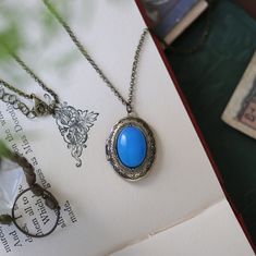 Semi-precious stone on a vintage brass, antiqued silver, or shiny silver oval locket, perfect to remember your loved ones. On 28 inches of antiqued brass chain. Choose from: Light Blue Sodalite, Blue Howlite, Blue Agate or Dark Blue Sodalite. I can change the chain to any length, just leave a note at checkout. Blue Oval Beads Jewelry For Gift, Blue Oval Locket Necklace, Oval Blue Locket Necklace, Blue Oval Cabochon Jewelry, Oval Blue Cabochon Jewelry, Blue Gemstone Necklace With Oval Cabochon, Blue Oval Jewelry For Memorial, Blue Oval Cabochon Gemstone Necklace, Oval Blue Jewelry For Memorial