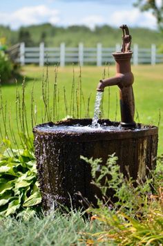 a water fountain in the middle of a field