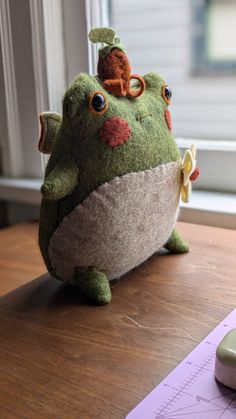 a stuffed animal sitting on top of a wooden table