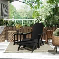 a deck with chairs and plants on it