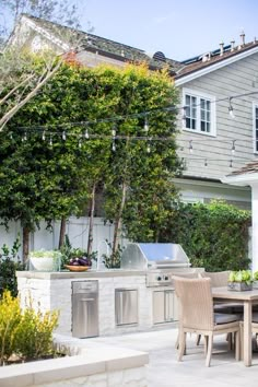 an outdoor kitchen and dining area is shown