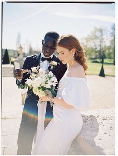 a bride and groom standing next to each other