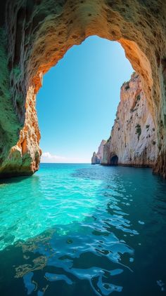 an ocean cave with blue water and rocks