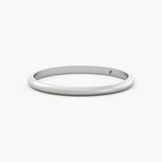 a plain white gold wedding band with a single diamond on the top and bottom edge