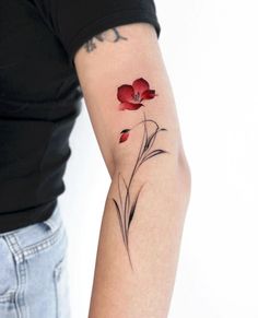 a woman's arm with a flower tattoo on the left side of her arm