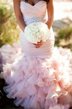 a woman in a wedding dress holding a bouquet