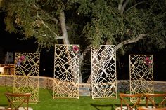 an outdoor ceremony set up with wooden chairs