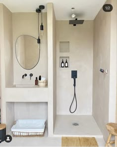 a bathroom with a sink, mirror and shower head in the wall next to it