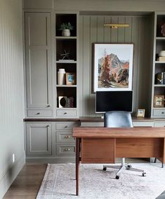 a home office with built - in bookcases and desk