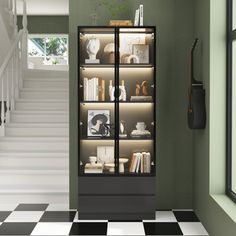 a book case sitting on top of a black and white checkered floor next to stairs