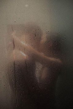 a woman's torso is seen through the frosted glass on a cold day