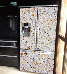 a black refrigerator freezer sitting inside of a kitchen