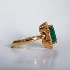 Read about our payment plans before proceeding.The Isis Emerald Scroll Diamond ring is an exquisite piece. Inspired by the details on architectural buildings in NYC, this ring features a stunning natural emerald framed by two baguette diamonds and round diamonds. Made for a true goddess with a touch of vintage vibe. Available in 14K solid yellow gold, white gold, and rose gold. 14K solid gold Natural 9*7mm emerald. Approx. 2.6ct. Comes with a certificate Natural baguette diamonds. Approx. 0.04ct Luxury 14k Gold Emerald Wedding Ring, Luxury Emerald Ring With Halo, Classic Gold Emerald Ring With Halo Setting, Luxury Gold Emerald Ring For Formal Occasions, Luxury Gold Emerald Ring With Halo Setting, Luxury Emerald Cut Gemstone Halo Ring, Elegant Yellow Gold Halo Ring With Gemstone, Luxury Emerald Rings With Halo Detail, Luxury Emerald-cut Emerald Ring With Halo Design