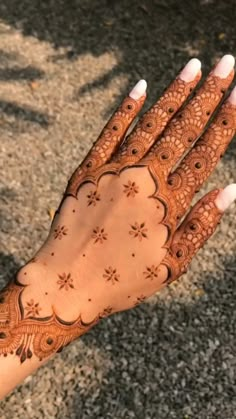 a woman's hand with henna on it