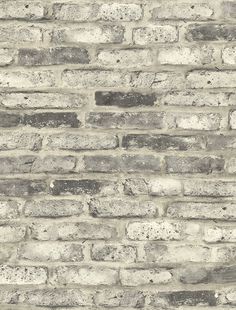 an old brick wall is shown in grey and white