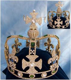 a gold crown with green and white stones on it's sides, in front of a blue background