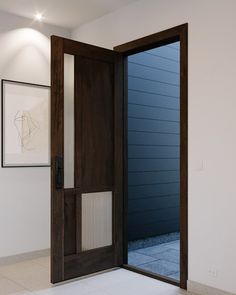 an open wooden door in a white room