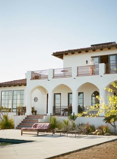 a large white house with lots of windows and balconies