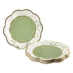 two green plates with gold rims and leaves on the sides, one is empty