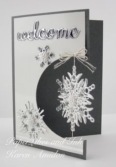 a black and white christmas card with snowflakes on it, which reads welcome