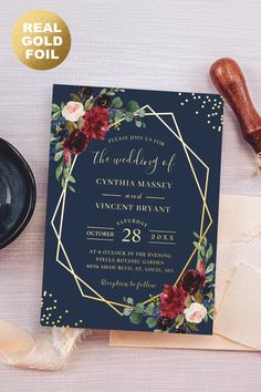 a wedding card with flowers and gold foil on it