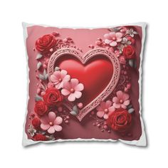 a red heart shaped pillow with flowers on it