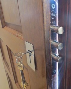 an open door with two keys on it