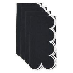 four black napkins with white scalloped edges