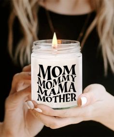 a woman holding a candle that says mom, mommy mama mother