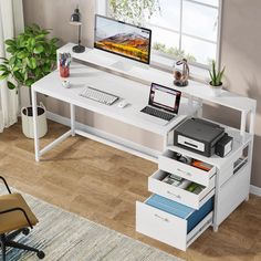 a computer desk with drawers and a laptop on it