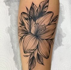 a black and white flower tattoo on the leg