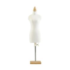 a white mannequin on a wooden stand