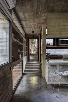 a chair sitting in the middle of a long hallway next to a counter top oven