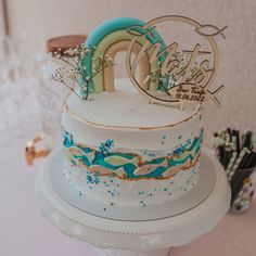 there is a wedding cake that has been decorated with blue and white frosting on it