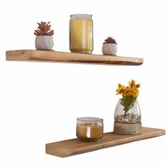 two wooden shelves with candles and vases on them