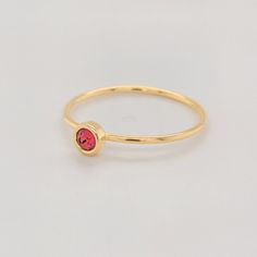 Celebrate your July birthday with the Large July Birthstone Ring, featuring a vibrant 4mm bold red CZ stone. This striking stone represents love and courage, making it a powerful addition to any jewelry collection. The ring is crafted with a 14K yellow gold-filled band, offering both elegance and durability. Whether worn alone or stacked with other personalized rings, this piece is a perfect way to showcase your unique style. Features 4mm CZ stone with a vibrant bold red hue. 14K gold-filled ban Adjustable Red Birthstone Ring, Red Stackable Birthstone Ring As Gift, Red Stackable Birthstone Ring Gift, Red 14k Gold Stackable Birthstone Rings, Gold Ruby Birthstone Ring With Round Band, Red 14k Gold Stackable Rings As Gift, Red Birthstone Ring With Round Stone For Gift, Red Birthstone Ring With Round Band, Gold Stackable Ruby Birthstone Ring