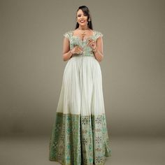 This magnificent piece is one of the true examples of traditional elegance meeting modern charm. The rich blend of traditional motifs and modern design elements makes this dress a versatile piece, suitable for special occasions like weddings, cultural ceremonies, or festive celebrations. Material Cotton Menen Thread Estimated delivery : 2 weeks Contact WhatsApp +1(304)-306-2784Email: contact@ethiopian.store Elegant Wedding Dresses With Resham Embroidery, Elegant Evening Dress With Traditional Drape For Reception, Festive A-line Wedding Gown, Traditional Drape Dress For Eid Reception, Traditional Drape Cutdana Dress For Reception, A-line Wedding Dress With Intricate Embroidery, Festive A-line Wedding Dress, Festive A-line Evening Dress For Wedding, Cutdana Dress For Eid Reception