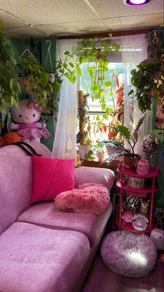 a living room filled with lots of plants and stuffed animals on the couches in front of a window