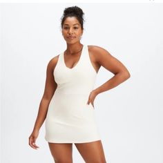 Product Description We Took Our Popular Medium Impact Sports Bra And Designed It Into A Dress That Features A V-Neck Design And Back Pocket. Features Built-In Bra External Pocket Removable Bra Cups Fabric 89% Polyester/11% Elastane Imported. In Color Egret Spring V-neck Athleisure Dresses, Sporty V-neck Tennis Dress For Spring, Sporty V-neck Tennis Dress, V-neck Stretch Workout Dresses, Stretch V-neck Workout Dress, V-neck Workout Dress, Fitted V-neck Tennis Dress For Sports, Athleisure V-neck Stretch Dress, Bra Dress